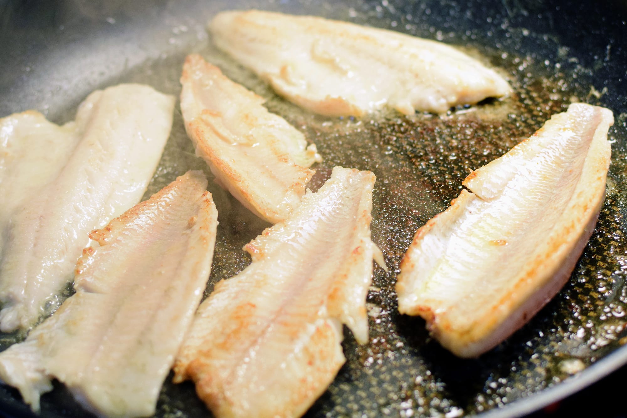 Delicious perch fillets on frying pan roasted in butter.